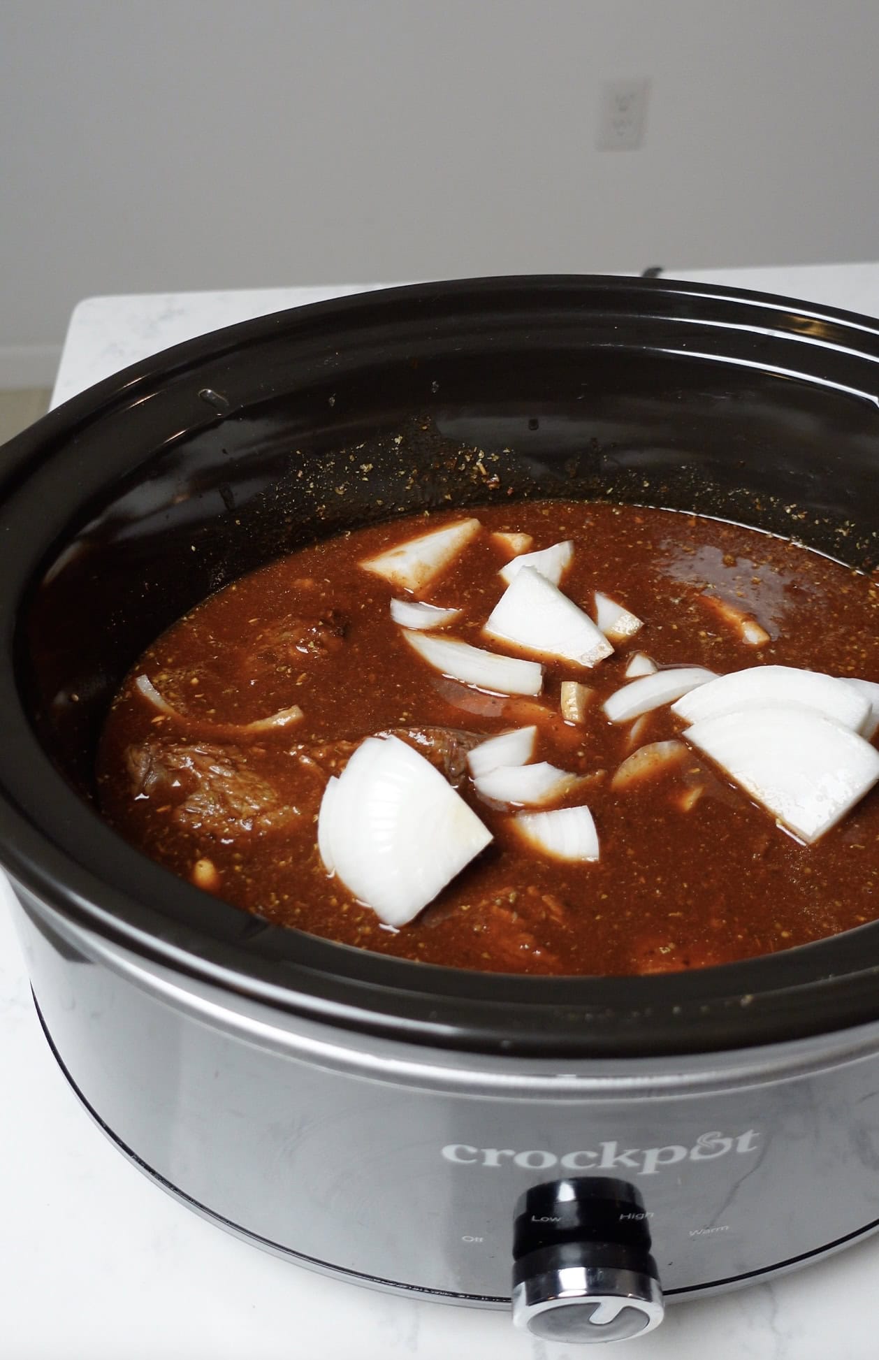 Onions and cause in a crock pot.